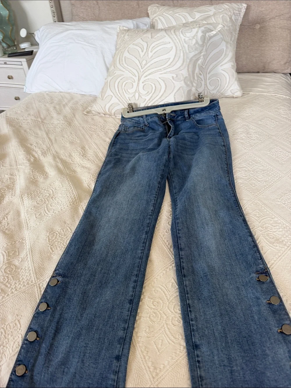 Charlie B Light Wash Button-Hem Straight Jeans with hem button detail.